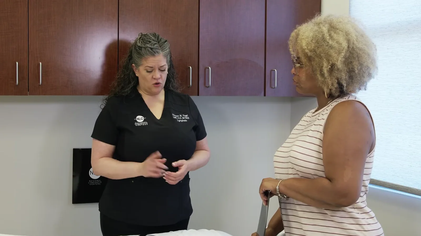 Sharon Vogel demonstrating the drainage technique with her hands during a training session at a National Lymphatic Centers clinic